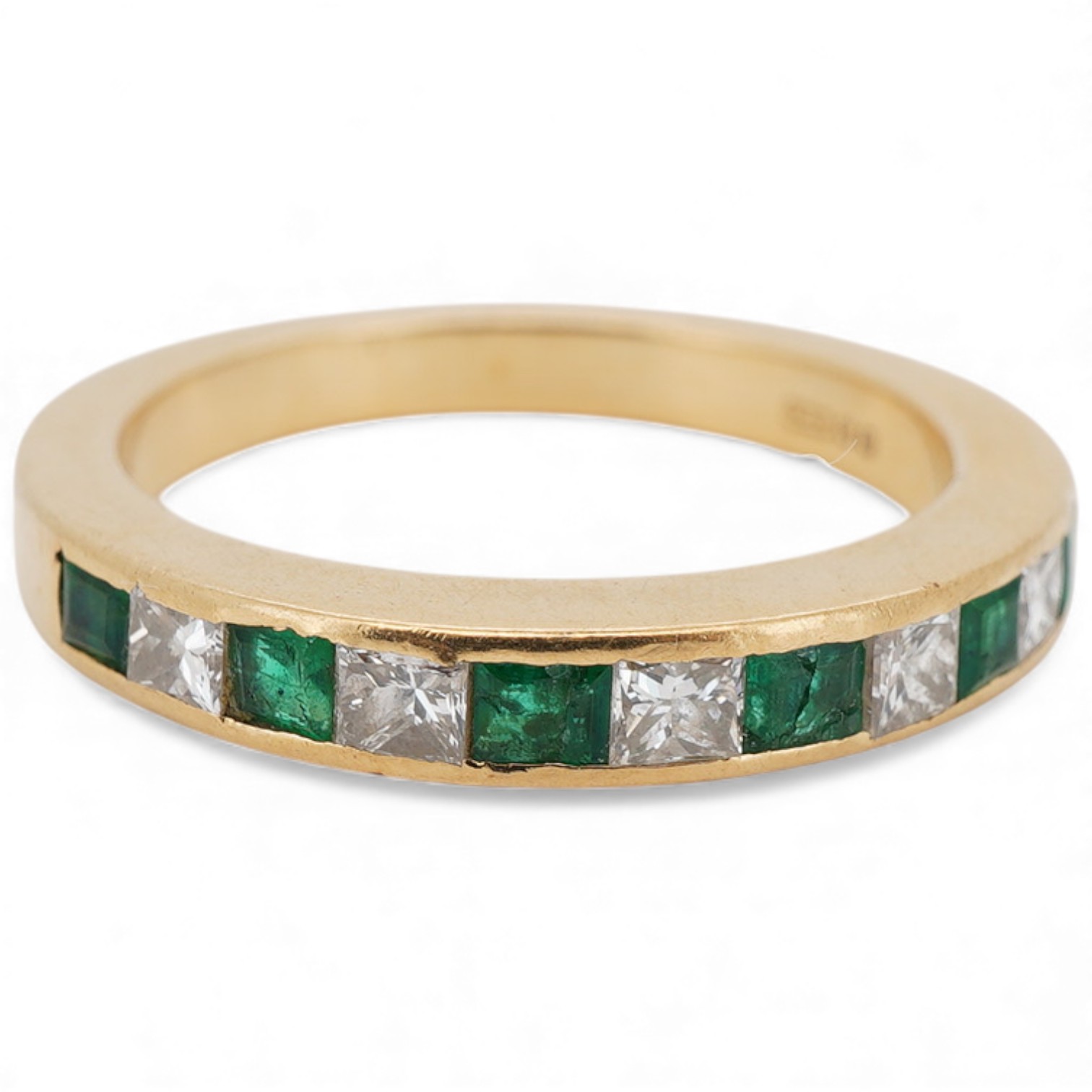 A recent 18ct gold, six stone emerald and five diamond set half hoop ring, size M, gross weight 4.3 grams.